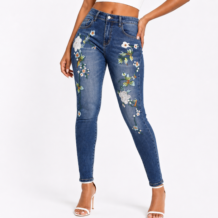 Full length skinny embroidered jeans in blue denim with slim pencil pants fit, flower pattern details, and urban outfit style