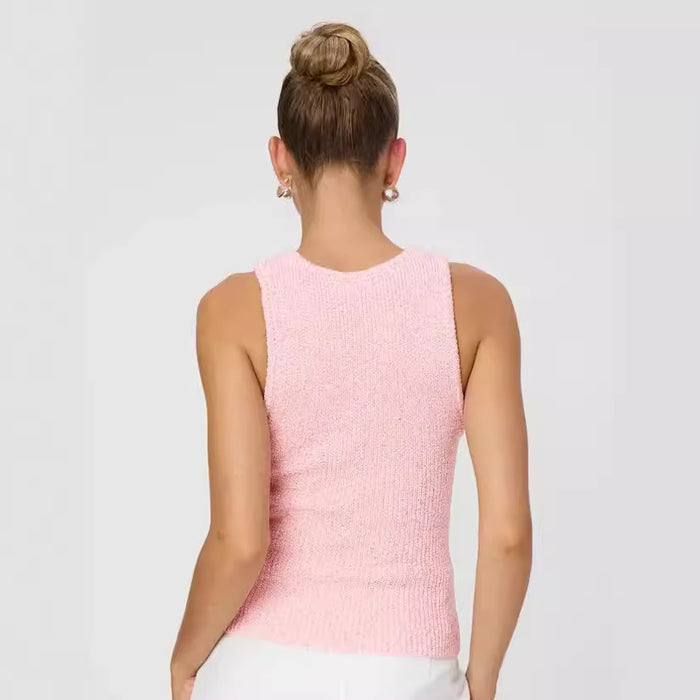 Person wearing a pink sleeveless top on a plain background