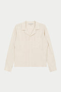 A beige long-sleeved woven shirt with a revere collar, oversized chest pocket, and pearl branded button fastening.