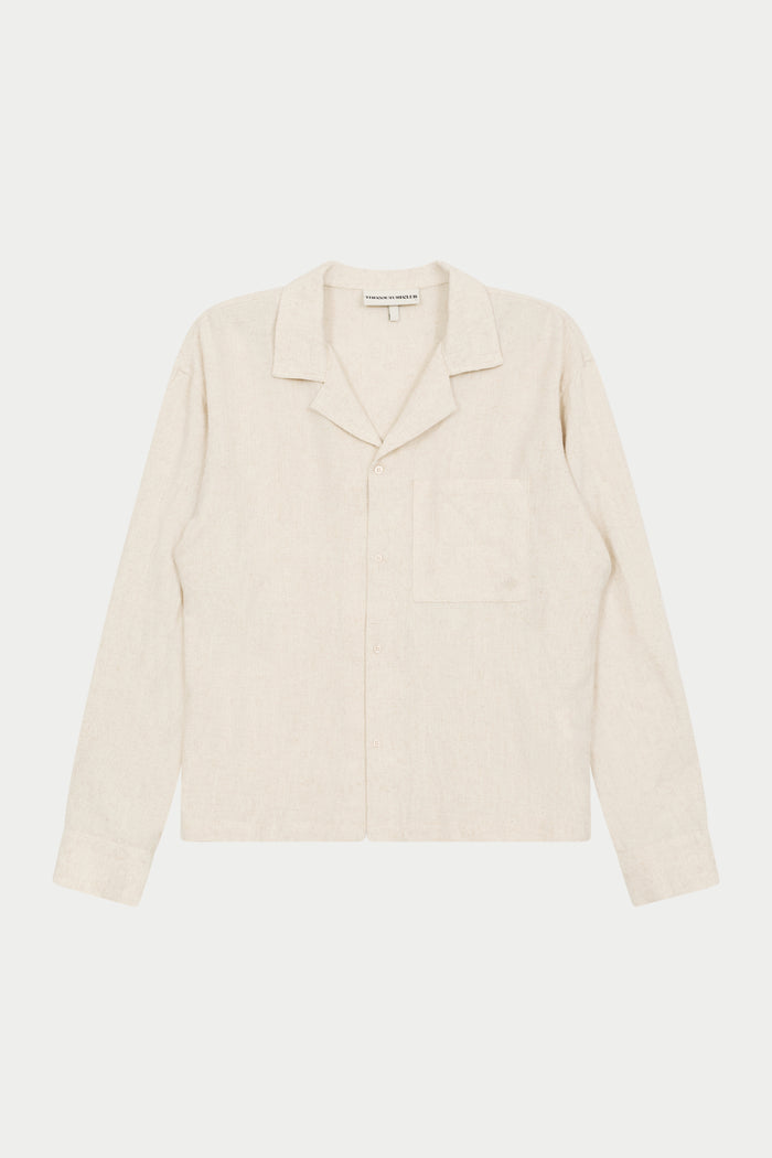 A beige long-sleeved woven shirt with a revere collar, oversized chest pocket, and pearl branded button fastening.