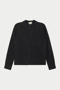 A long-sleeved black woven shirt with a revere collar, oversized chest pocket, and pearl branded button fastening.