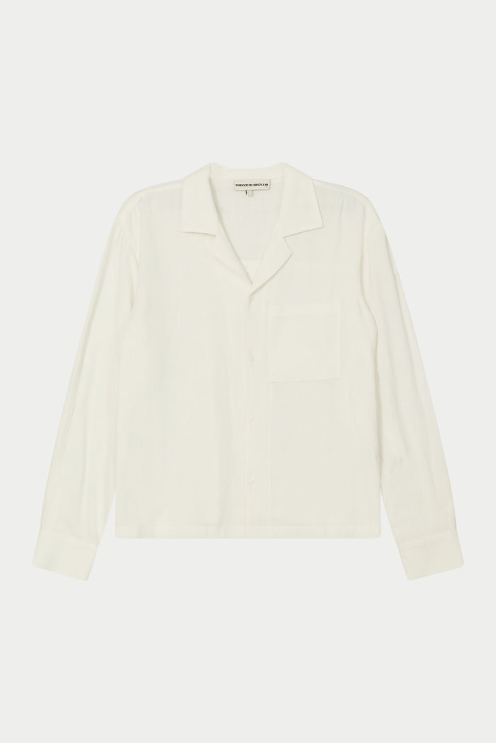 A white, long-sleeved, relaxed fit woven shirt with a revere collar and an oversized chest pocket, displayed on a plain background.