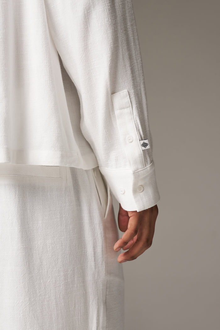 Close up detail shot of the back of a mans cuff against a neutral background