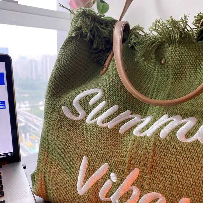 Side profile of self-supporting tote bag with magnetic closure standing upright on marble surface