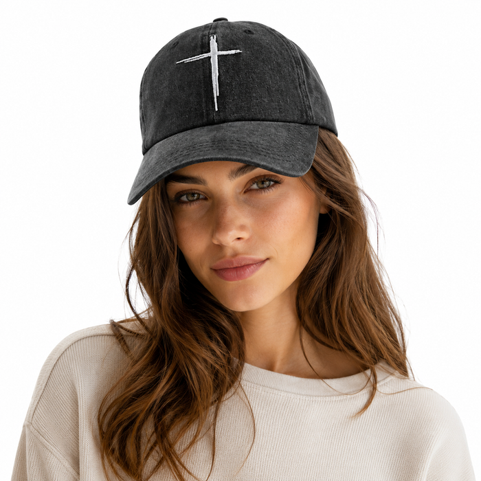 Washed black cotton baseball cap with subtle cross embroidery and distressed vintage finish