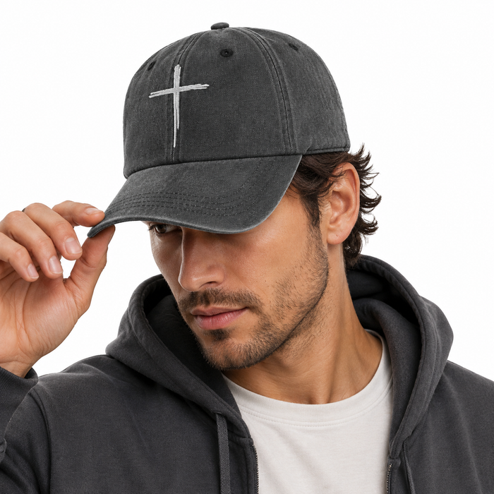 Close-up of cross embroidered cap showing soft washed cotton texture and curved brim