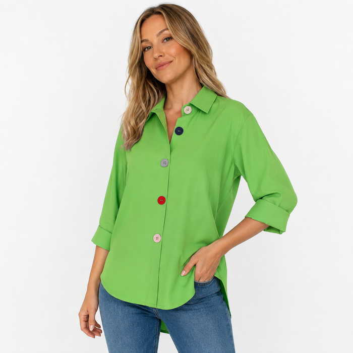 Green women's button down shirt shown in a three-quarter studio pose with a loose silhouette and colorful front buttons.
