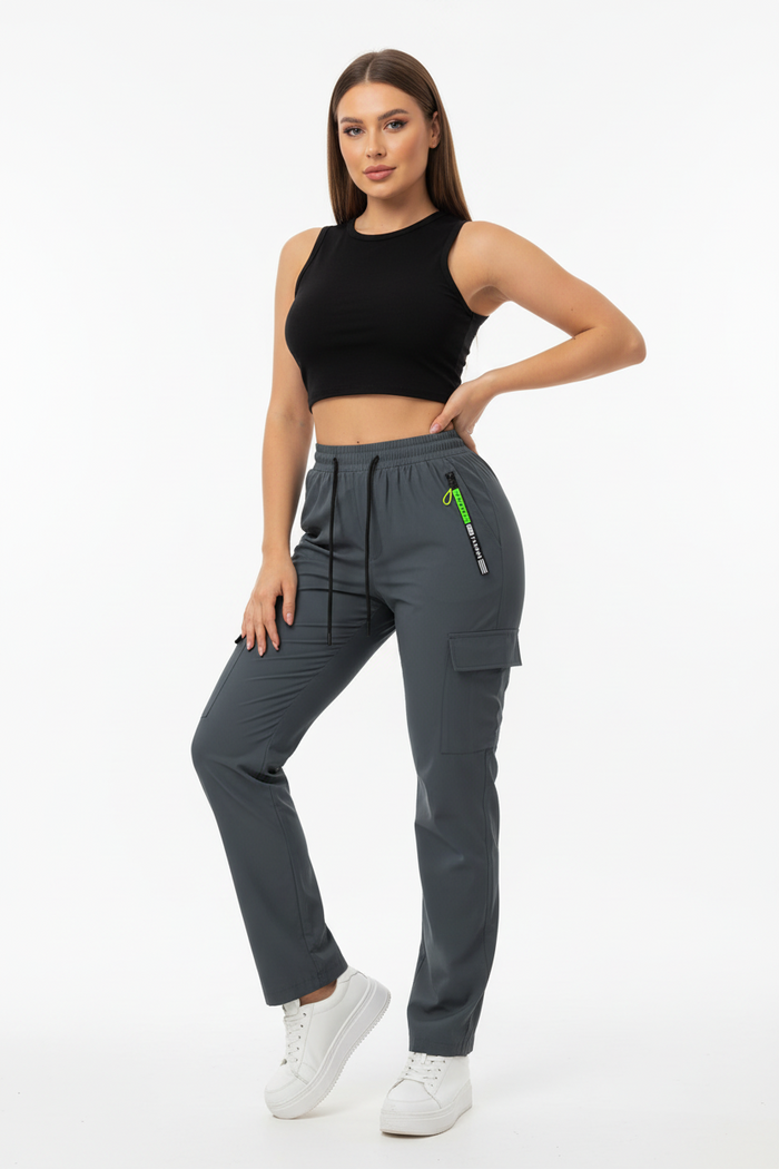Women's utility-style pants shown from the side with a relaxed leg and functional pocket design