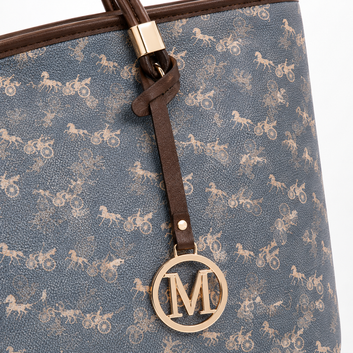 Close-up of women's tote bag patterned surface, brown strap detail and round gold-tone M charm