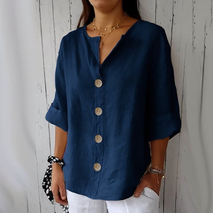 loose fit women's v-neck linen button shirt side view silhouette drape comfort white pants gold accessories