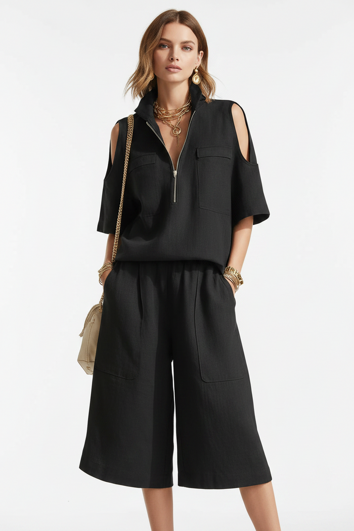 Flat lay of the complete two-piece outfit on a pastel background with sandals and gold hoops