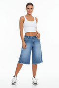 Front view of women's ripped denim shorts with raw hem and button detail