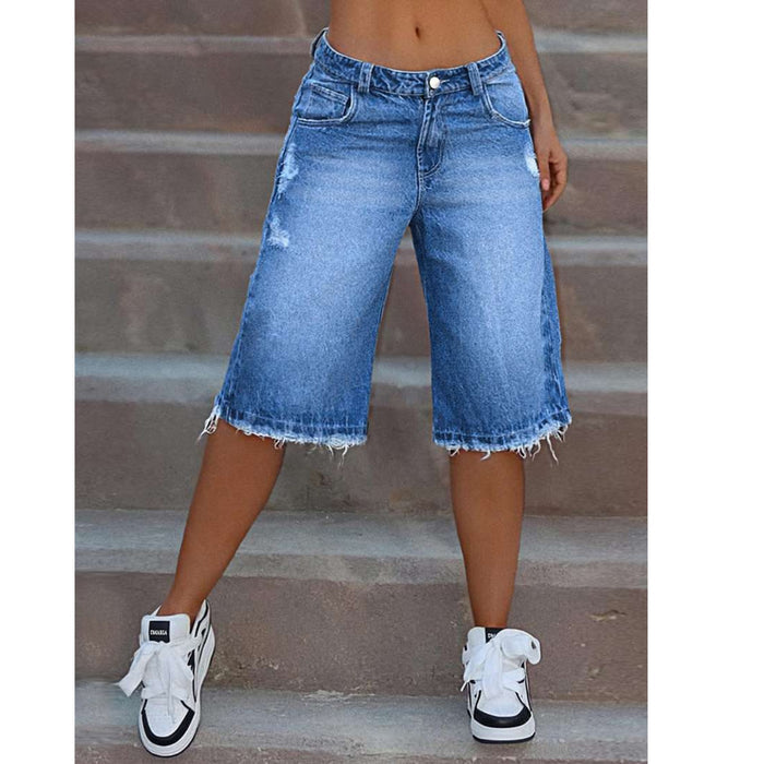 Close-up of raw edge finish on women's denim shorts