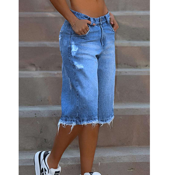 Blue ripped denim shorts paired with a fitted tank top