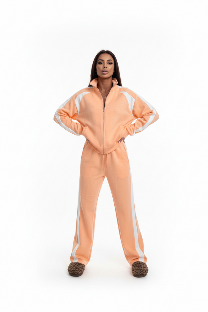 Side profile of orange polyester tracksuit set on a model, regular sleeve length, slim trouser cut
