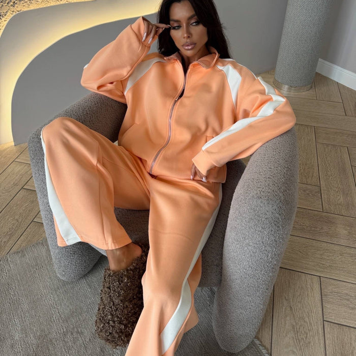 Woman in peach tracksuit sitting on a gray chair in a modern room.